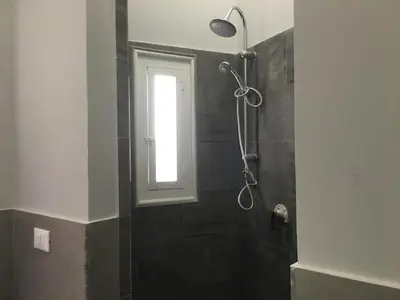 a bathroom with a shower with a window at YooRoom in Palermo