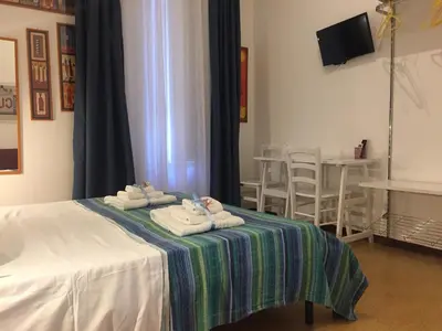 a room with a bed with folded towels on it at YooRoom in Palermo