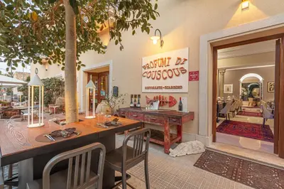 a dining room with a table and chairs and a restaurant at Ghibli Hotel in San Vito lo Capo