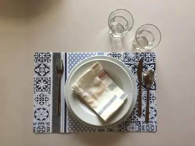 a table with a plate with a napkin and fork and knife at Casa del Sale, a 50 m dalla spiaggia in Lascari