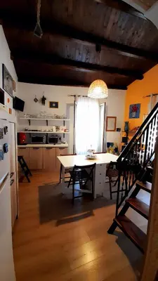 a kitchen and dining room with a table and a refrigerator at Guest House Beati Paoli in Palermo