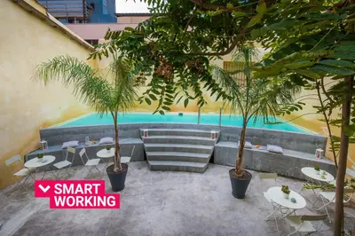 a pool with two palm trees and tables and chairs at Casa d'arte Ugdulena con Piscina e Terrazza by Wonderful Italy in Palermo