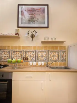 a kitchen with a sink and a picture on the wall at Casa d'arte Ugdulena con Piscina e Terrazza by Wonderful Italy in Palermo