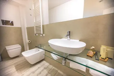 a bathroom with a sink and a toilet at Suite Quaroni in Palermo