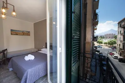 a bedroom with a bed on a balcony at Il Genoardo Della Zisa in Palermo