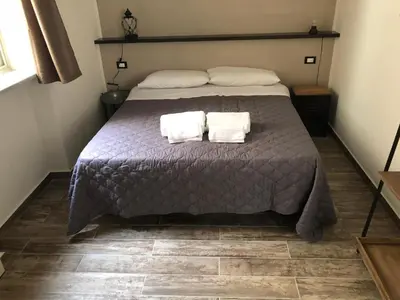 a bedroom with a bed with two towels on it at Il Genoardo Della Zisa in Palermo