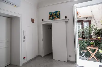 a hallway with a door and a mirror at Ai Mori in Palermo