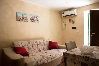a living room with a couch and a table at Casa Assisi in Palermo
