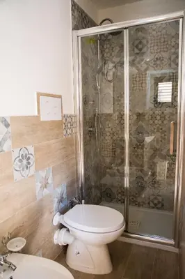 a bathroom with a toilet and a shower at Casa Assisi in Palermo