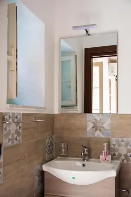 a bathroom with a sink and a mirror at Casa Assisi in Palermo