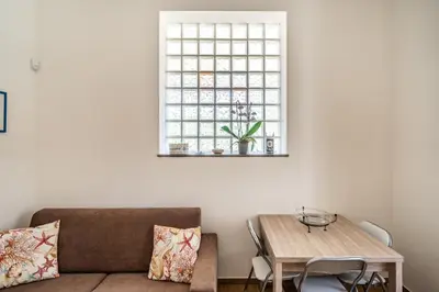 a living room with a couch and a table at Le Casette Di Maria Pia in Mondello
