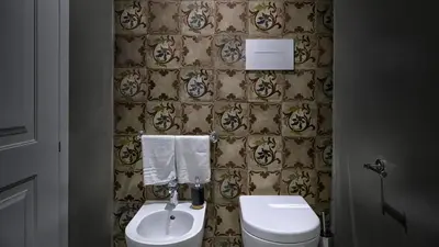 a bathroom with a toilet and a sink at Suite del Ponte Normanno in Palermo