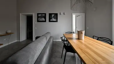 a living room with a couch and a wooden table at Suite del Ponte Normanno in Palermo