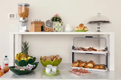a shelf with bread and other foods on it at Affittacamere Sirius in San Vito lo Capo