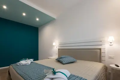 a bedroom with a bed with towels on it at Affittacamere Sirius in San Vito lo Capo