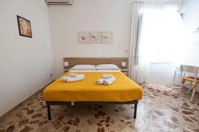 a bedroom with a bed with towels on it at Casa Lisa a due passi dal mare con ampio giardino in San Vito lo Capo