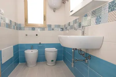 a bathroom with a sink and a toilet at Casa Lisa a due passi dal mare con ampio giardino in San Vito lo Capo