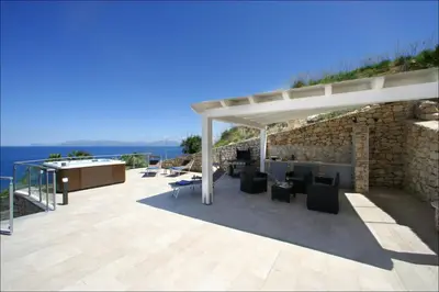 a pergola on a patio with a view of the ocean at Villa Antonia - Vasca Idromassaggio Terrazza Vista Mare in San Vito lo Capo