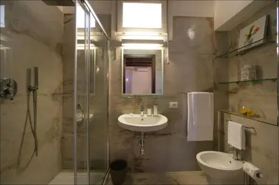 a bathroom with a sink and a toilet and a shower at Villa Antonia - Vasca Idromassaggio Terrazza Vista Mare in San Vito lo Capo
