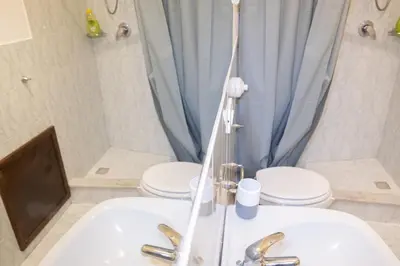 a bathroom with a white sink and a toilet at Casa Salinas Centro Storico in Palermo