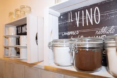 a chalkboard on a shelf next to jars of food at Casa Salinas Centro Storico in Palermo