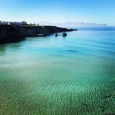 a large body of water with two boats in it at GíeffeHOUSE in Terrasini