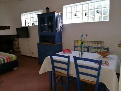 a room with a table with two chairs and a blue cabinet at DaRiMaPa House in Mondello