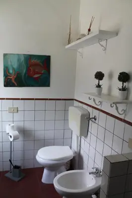 a bathroom with a toilet and a sink at DaRiMaPa House in Mondello