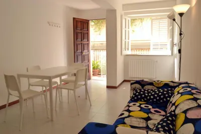a living room with a table and a couch at Casa DahLia Mondello in Mondello