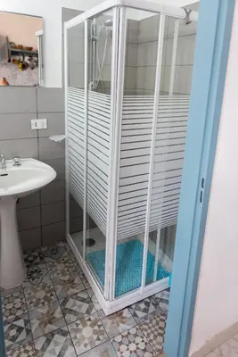 a shower in a bathroom with a sink at L' Arena Suite - Sicilian style 140 mq flat with balcony and Arena seeview in Castellammare del Golfo