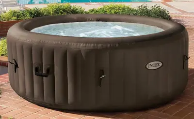 a large hot tub sitting on a brick ground at Villa Ancora in Campofelice di Roccella