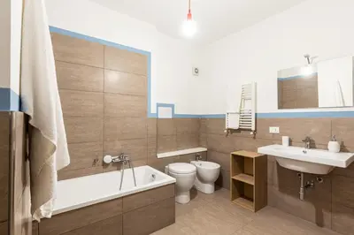 a bathroom with a tub and a toilet and a sink at Casetta Allegra in Palermo