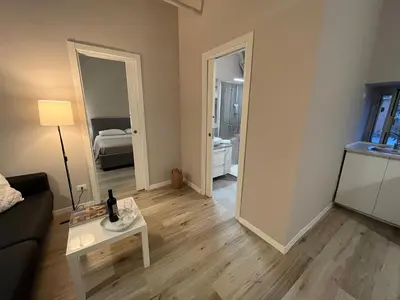 a living room with a couch and a table and a mirror at Appartamento Valverde in Palermo