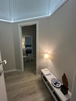 a room with a table with a lamp and a mirror at Appartamento Valverde in Palermo