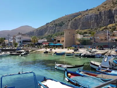 a group of boats are docked in a harbor at Casa Maro' in Palermo
