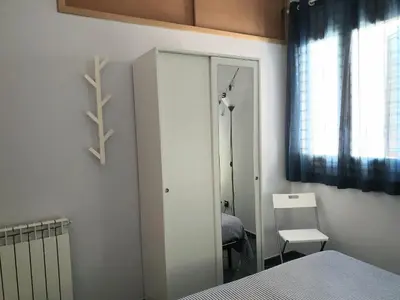 a bedroom with a mirror and a bed and a window at Casa Maro' in Palermo