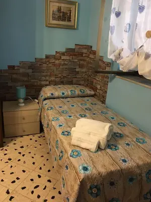 a bedroom with two beds with towels on it at Big Mom House in Palermo
