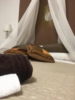 a bedroom with a bed with pillows on it at Alter Ego in Lascari