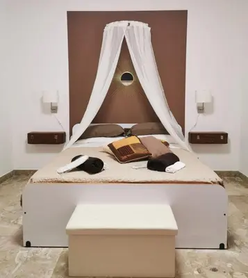 a bedroom with a bed with a canopy at Alter Ego in Lascari