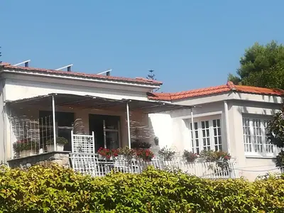 a white house with white fences and flowers at La stanza di Angi a Mondello in Palermo