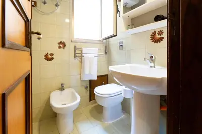 a small bathroom with a toilet and a sink at GuestHost - Palermo Functional Studio in Palermo