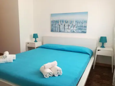 a bedroom with a bed with towels on it at Casa Vacanze Aurora Boreale in Alcamo Marina