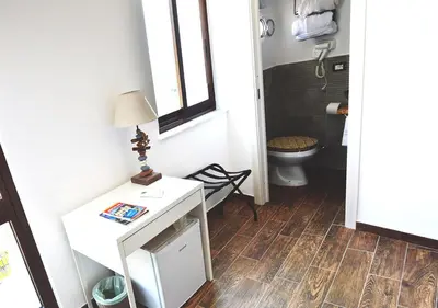 a bathroom with a white table and a toilet at Case Vacanza Calamaro in Trabia