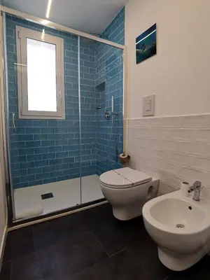a bathroom with a toilet and a shower and a sink at Mizzika Vacanze in Castellammare del Golfo