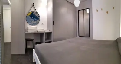 a bedroom with a bed and a table with a mirror at Mizzika Vacanze in Castellammare del Golfo