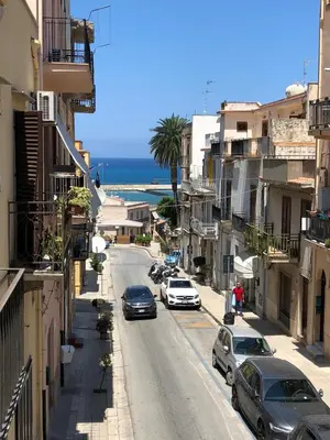 a city street with cars parked on the side of the road at Mizzika Vacanze in Castellammare del Golfo