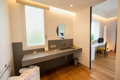 a bathroom with a sink and a mirror at Unìco Boutique Hotel d'Arte in Mondello