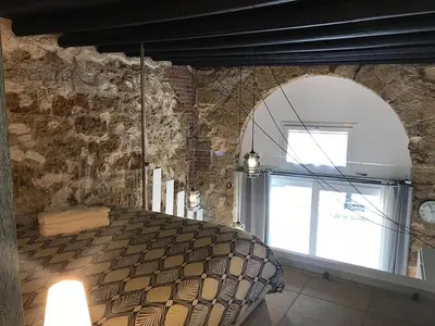 a bedroom with a bed with a large window at La Vecchia Stalla in Palermo