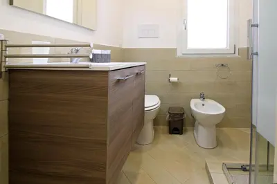 a bathroom with a toilet and a sink at centruMaqueda in Palermo