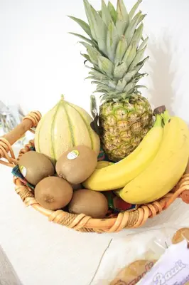 a basket of fruit with bananas kiwis and melons at B&B d'Orleans in Palermo